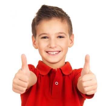 Little boy smiling with thumbs up