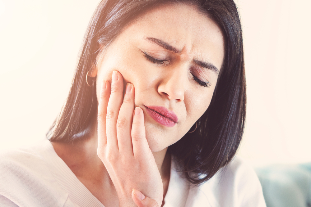 woman suffering from tooth pain