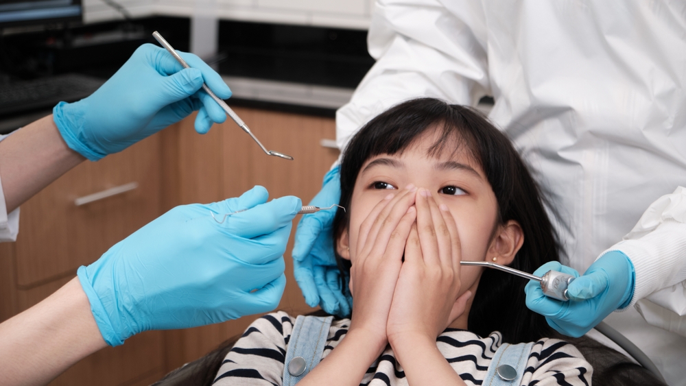 child with dental anxiety at dentist